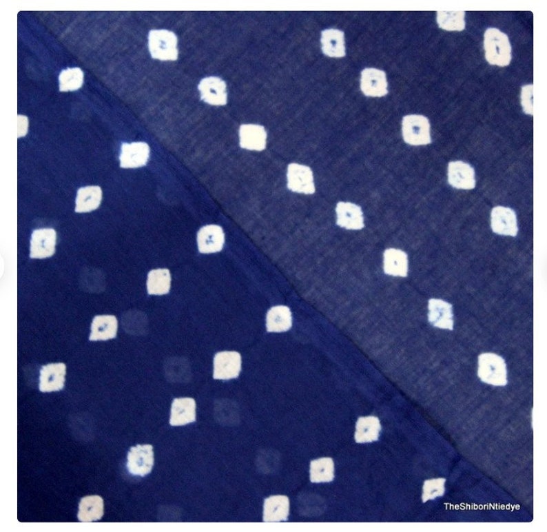 May include: A blue fabric with a white diamond pattern. The fabric is folded in half, showing two different sides of the pattern.