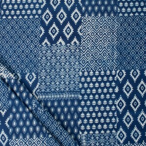 May include: A dark blue fabric featuring a patchwork design of various white geometric patterns, including diamonds, floral motifs, and small repeating shapes, arranged in a grid-like layout across the surface of the textile material.