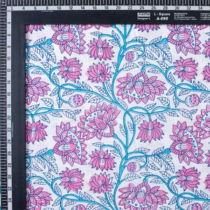 May include: White cotton fabric with a repeating pattern of pink and blue flowers. The fabric has a subtle texture and is ideal for crafting or sewing projects.