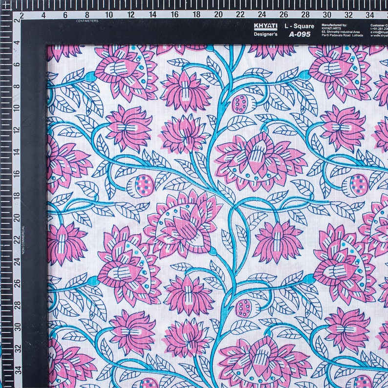 May include: White cotton fabric with a repeating pattern of pink and blue flowers. The fabric has a subtle texture and is ideal for crafting or sewing projects.