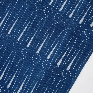 May include: Blue fabric with a white pattern of diagonal lines and dots. The pattern resembles raindrops.