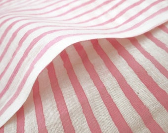 May include: Pink and white striped fabric with a textured linen look. The fabric is folded over, showing the stripes from both sides.