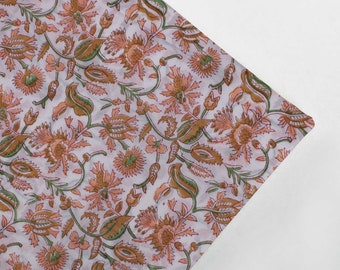 May include: A white fabric with a floral pattern in shades of peach and green. The fabric has a delicate, hand-printed look.