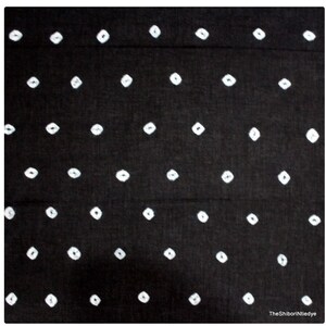 May include: Black fabric with a white shibori tie-dye pattern of small diamond shapes.