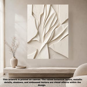 May include: A rectangular canvas wall art piece featuring an off-white, cream-colored abstract design with raised, layered botanical shapes. The composition displays deep shadows and textured surfaces that create a three-dimensional visual effect.