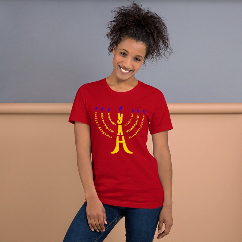 May include: Red t-shirt with a yellow menorah design. The menorah has the word "YAH" in the center and the words "Youth, King,  Love,  Order,  Knowledge,  Hope,  Faith,  All,  His" around the menorah.