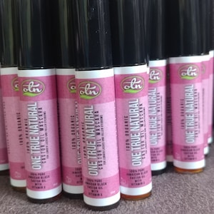 May include: Multiple bottles of 100% organic One True Natural Castor Oil Mascara. The bottles are black with a pink label and the text "One True Natural Castor Oil Mascara" is printed on the label.