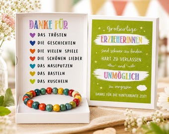 May include: A white gift box with a colorful beaded bracelet inside. The box contains text in German, including "Danke Für" and a list of things. The box also has a card with text in German, including "Großartige ERZIEHERINNEN".