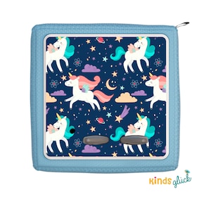 May include: A blue zippered pouch with a white unicorn and star pattern. The pouch has a dark blue background with white stars, pink clouds, and a crescent moon. The text "kinds glück" is printed on the bottom of the pouch.
