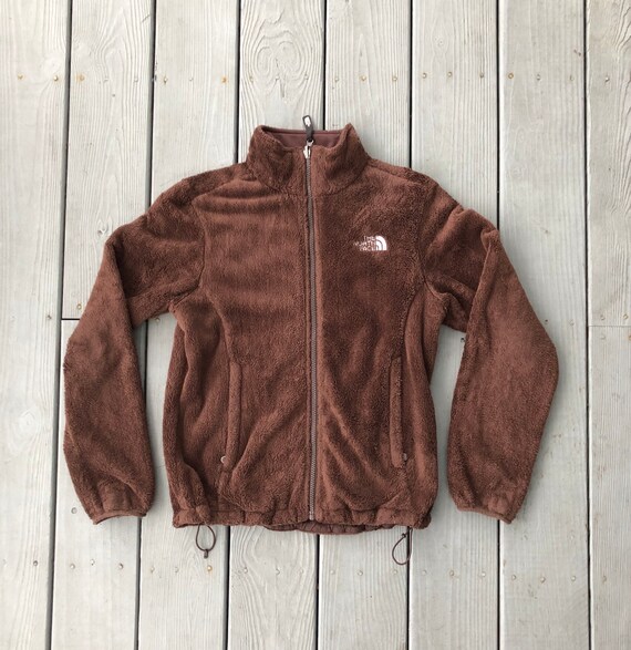 red fuzzy north face jacket