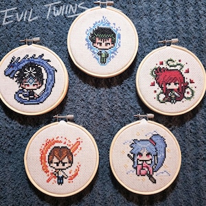 May include: Five embroidered hoops with different anime characters. Each hoop features a different character with a unique background and color scheme. The characters are surrounded by a white background and are framed in a wooden hoop.