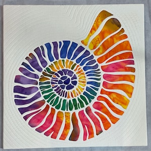 Quilt on Canvas - Spiral Shell. Individual applique shapes combine to create this colorful shell design.