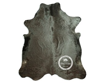 May include: A gray and black cowhide rug with a white logo that says "Prime Cowhides" and a bull silhouette.