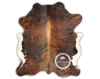 May include: Brown and white cowhide rug with a natural, spotted pattern. The rug has a white border and a logo in the center that reads "Prime Cowhides Hides & Rugs Est. 1999".