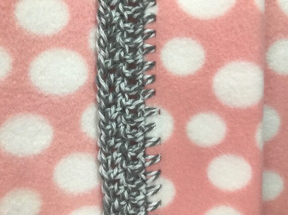 pink baby blanket with white polka dots