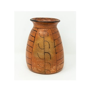 May include: A brown ceramic vase with a geometric design in black paint. The vase has a rounded body and a slightly flared opening.