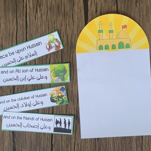 May include: Four green and white cards with Arabic text and illustrations. The text reads "Peace be upon Hussain,  "السلام على الحسين", "and on Ali son of Hussain, "وعلى علي ابن الحسين", "and on the children of Hussain, "وعلى أولاد الحسين", and "and on the friends of Hussain, "وعلى أصحاب الحسين".