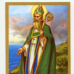 May include: A painting of Saint Patrick, a Christian missionary and patron saint of Ireland, depicted in a green robe with a gold trim and a blue sash. He holds a staff with a shamrock at the top and is standing on a green hill with a blue ocean in the background. There are snakes at his feet.