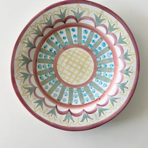 May include: A set of three ceramic mugs with a speckled, matte finish. The mugs are in shades of blue, green, and white. Each mug has a rounded handle and a simple, modern design. Perfect for coffee or tea.