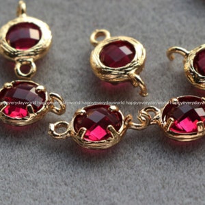 May include: Gold-tone metal connector charms with red faceted glass stones. Each charm has a loop on either side for attaching to jewelry.