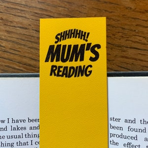 May include: Yellow bookmark with black text that reads "SHHHHH! MUM'S READING".