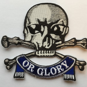 May include: An embroidered patch featuring a white skull and crossbones with a blue banner that reads "OR GLORY".