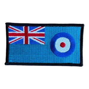 May include: An embroidered patch featuring the flag of the British Indian Ocean Territory. The flag is blue with a red, white, and blue Union Jack in the upper left corner and a white circle with a red center in the lower right corner.