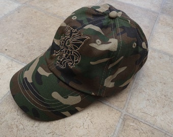 Camouflage cap with black  pendragon embroidered design