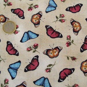 May include: A beige fabric with a repeating pattern of colourful butterflies. The butterflies are in shades of blue, red, orange, and brown. The fabric has a subtle texture.