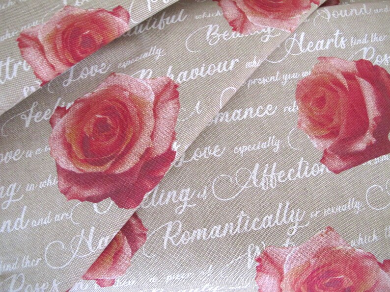 May include: Beige fabric with a repeating pattern of red roses and white cursive text. The text includes phrases like "Love", "Romance", "Affection", and "Beautiful".
