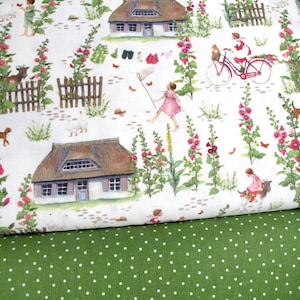 May include: Fabric with a whimsical countryside pattern. The design features illustrations of cottages, children, animals, and flowers in a soft watercolor style. The background is white, and the fabric below is green with white polka dots.