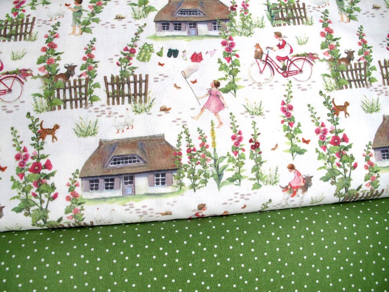May include: Fabric with a whimsical countryside pattern. The design features illustrations of cottages, children, animals, and flowers in a soft watercolor style. The background is white, and the fabric below is green with white polka dots.