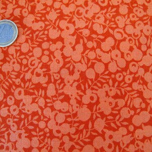 May include: Red fabric with a white floral pattern. The pattern features small circles, leaves, and larger, more abstract shapes.