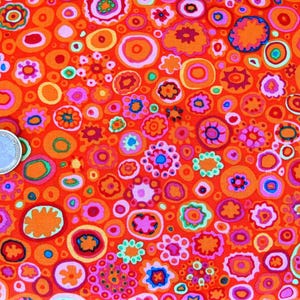 May include: A bright orange fabric with a repeating pattern of colourful circles and flowers. The circles are outlined in black and filled with various colours, including pink, green, blue, and yellow. The flowers are also outlined in black and have a variety of colours, including red, orange, and purple.