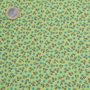 May include: Green fabric with a repeating pattern of small blue flowers and brown stems.