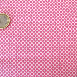May include: Pink fabric with a white polka dot pattern. The fabric is shown with a Euro coin for scale.
