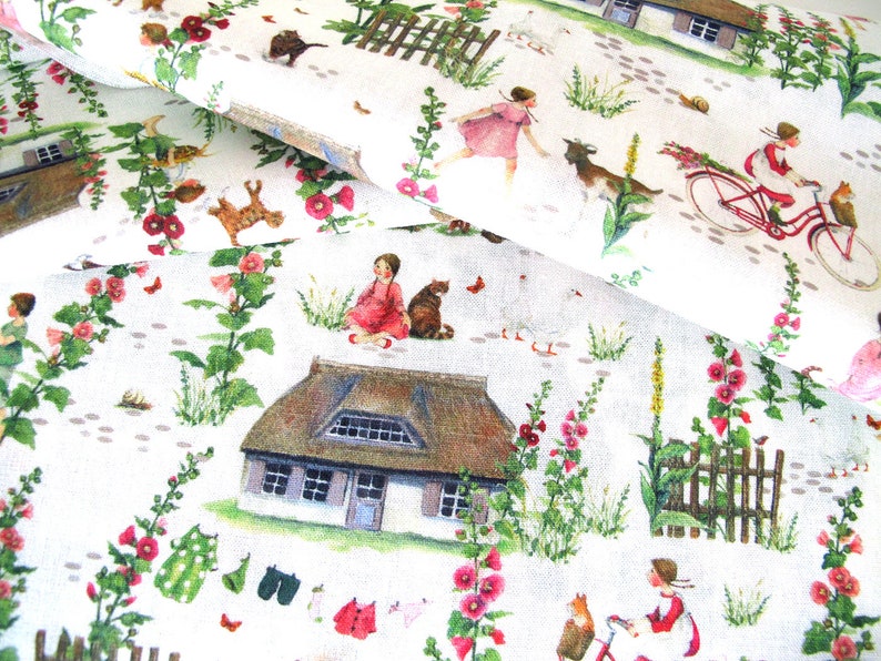 May include: White fabric with a whimsical print featuring a rural scene. The design includes a thatched-roof cottage, children, animals, flowers, and a red bicycle. The fabric is decorated with pink and red flowers.