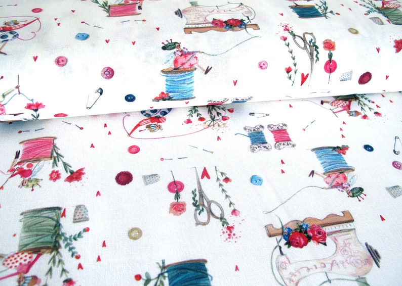 May include: White fabric with a repeating pattern of sewing-themed illustrations. The design includes spools of thread, sewing machines, scissors, buttons, thimbles, and floral accents in pink, blue, and green. Small red hearts are scattered throughout.
