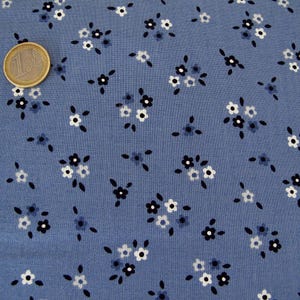 May include: A blue fabric with a white and black floral pattern. The fabric is covered in small, evenly spaced flowers.