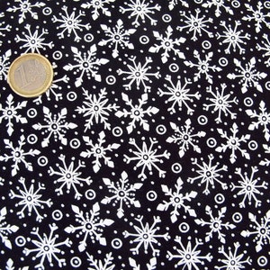 Peut inclure: Tissu noir avec un motif de flocons de neige blancs. Les flocons de neige sont de différentes tailles et sont dispersés aléatoirement sur le tissu.