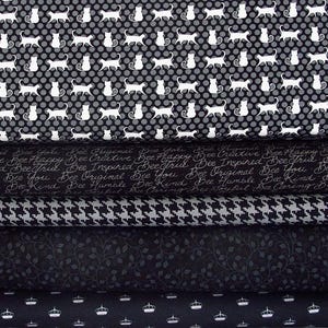 Peut inclure: Cinq échantillons de tissu dans des motifs noir et blanc. Le premier échantillon présente un motif répétitif de chats blancs sur un fond noir. Le deuxième échantillon présente un motif répétitif de texte blanc sur un fond noir. Le texte dit "Bee Creative Bee Happy Bee Inspired Bee True Bee Original Bee You Bee Humble Bee Kind Bee Joyful". Le troisième échantillon présente un motif pied-de-poule noir et blanc. Le quatrième échantillon présente un motif répétitif de petites feuilles blanches sur un fond noir. Le cinquième échantillon présente un motif répétitif de couronnes blanches sur un fond noir.