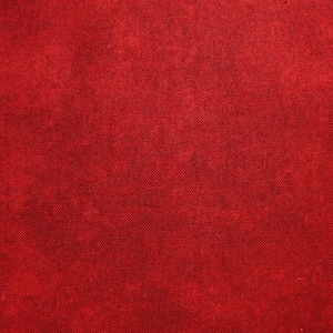 Può includere: Un primo piano di un tessuto rosso solido con una superficie testurizzata.