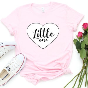 Little One Ddlg Shirt, - Super Soft 100% Cotton T-shirt With Short Sleeves and Crew Neckline in Heather Peach Color. Available sizes: XS, S, M, L, XL, 2XL, 3XL*.