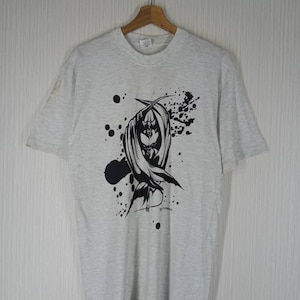 May include: A gray t-shirt with a black and white graphic print of a figure with wings and a halo. The graphic is surrounded by black paint splatters.