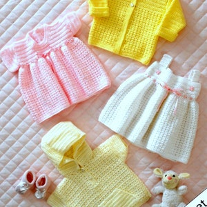 May include: A collection of handmade crochet baby clothes in various colors. Includes a yellow cardigan, a pink dress, a white dress, and a yellow hooded shirt. The sizes are 14-24 inches (36-61 cm). Also includes a pair of baby shoes and a stuffed animal.