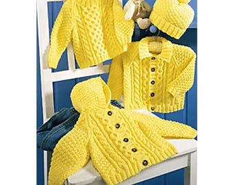 May include: Three yellow knitted cardigans with button closures and cable knit patterns. One cardigan has a hood. A yellow knitted hat with a pom pom sits on top of a white chair.