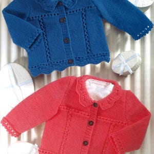 May include: Two knitted baby cardigans, one blue and one pink, with a white collar and button closure.