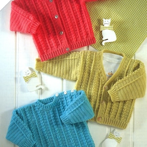 May include: Three crocheted baby sweaters in different colors: red, yellow, and blue. Each sweater has a cable knit pattern and button closure.