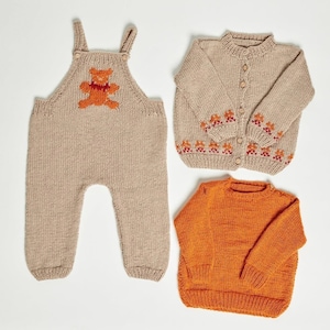 May include: Three knitted baby clothes in beige and orange. A beige knitted jumpsuit with a teddy bear design, a beige knitted cardigan with a button closure and orange trim, and an orange knitted sweater.