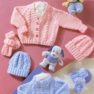 May include: Two knitted baby outfits, one pink and one blue. The pink outfit includes a cardigan, hat, and mittens. The blue outfit includes a cardigan, hat, and mittens. Both outfits feature a cable knit pattern.